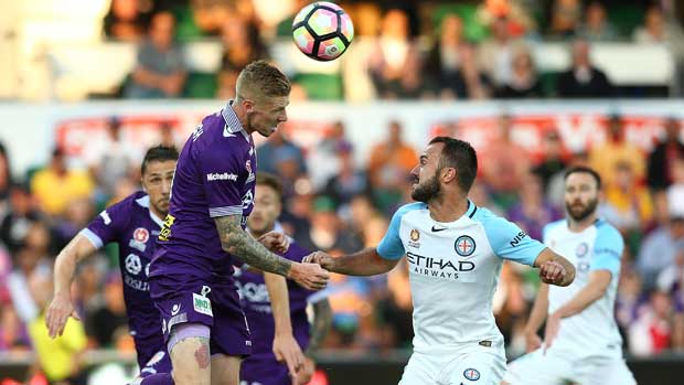 Andy Keogh rises highest to win a header over the Melbourne City defence.